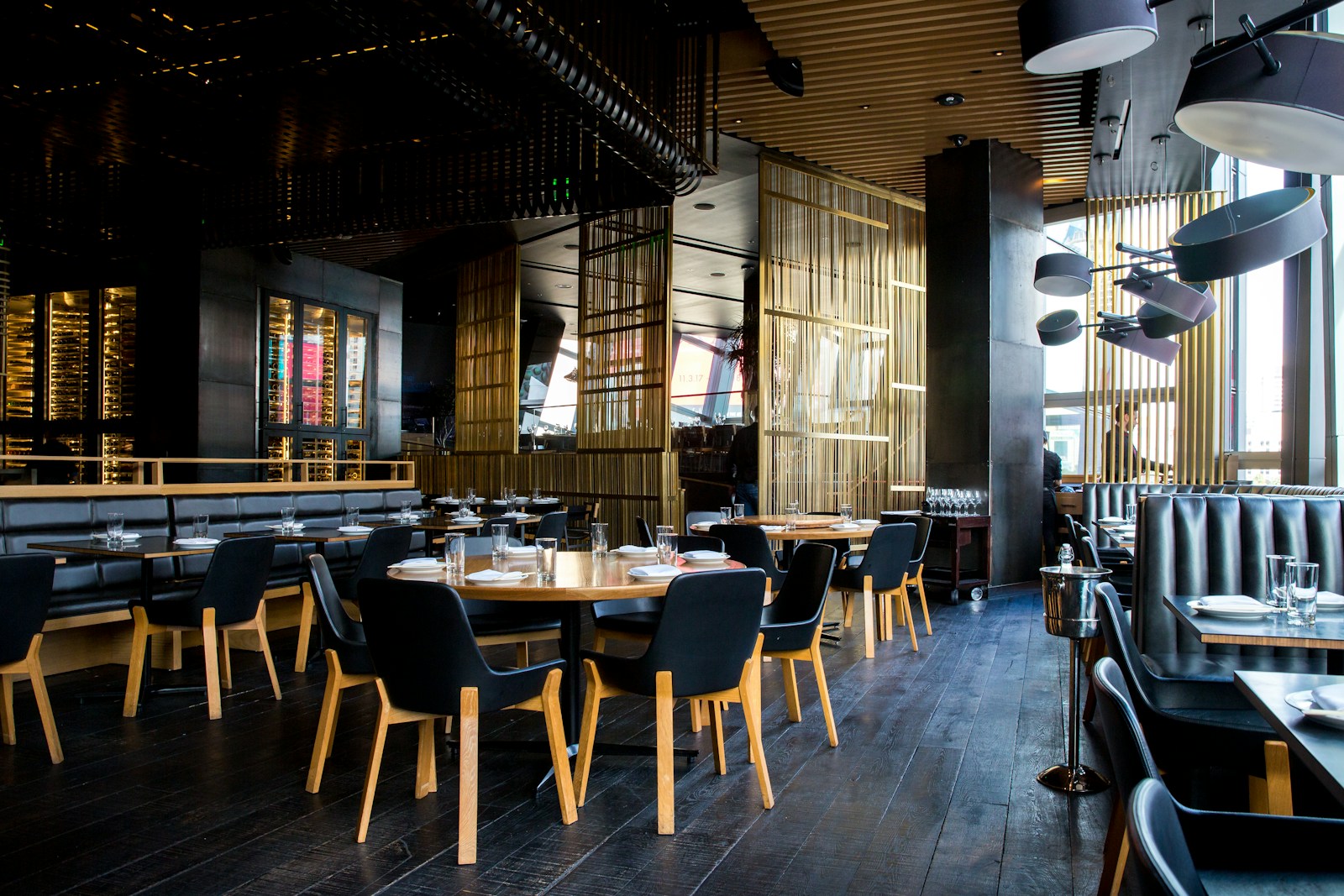 Warm, welcoming restaurant with an open dining room and hanging lights